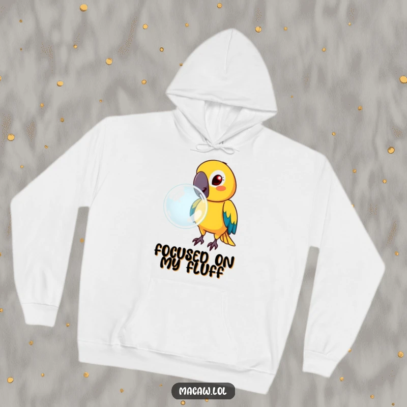 Funny macaw with a determined face, blowing a large bubble, on a cozy hoodie, radiating focused humor.