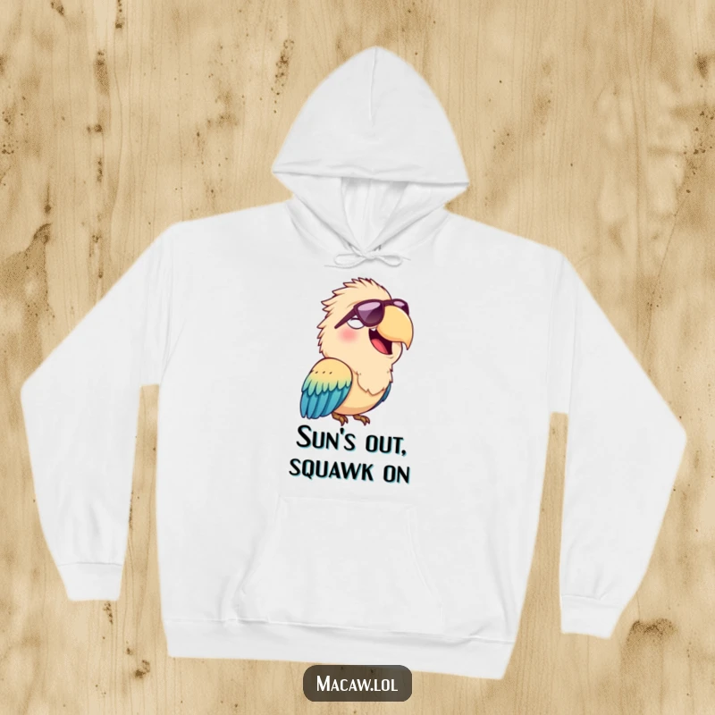 Funny hoodie featuring a cheerful macaw bird squawking happily while wearing a pair of cool sunglasses, perfect for cozying up.