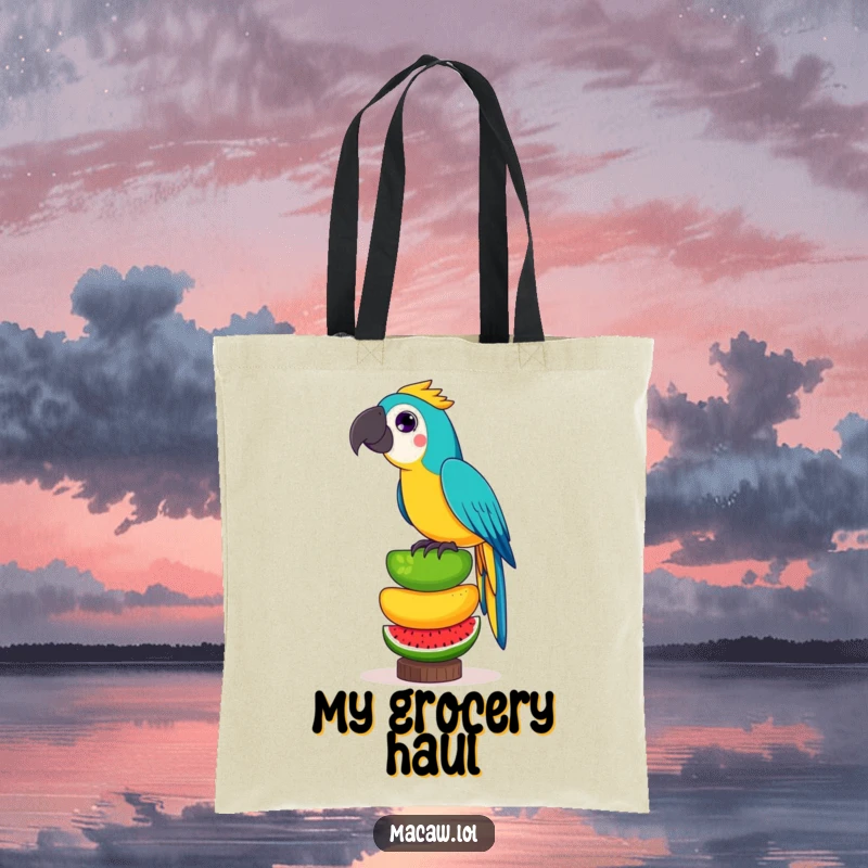 Funny tote bag showing a playful macaw bird precariously balancing a tall stack of exotic fruits, perfect for grocery runs.